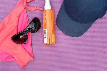 Image showing Top view of summer accessories on purple background