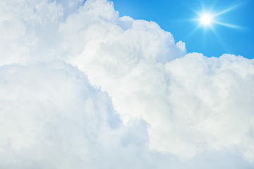 Image showing typical blue sky with sun and clouds background