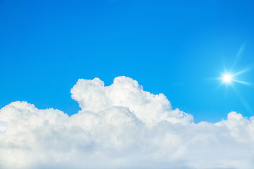 Image showing typical blue sky with sun and clouds background