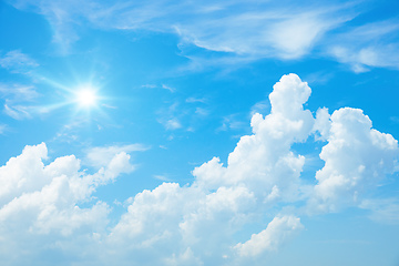 Image showing typical blue sky with sun and clouds background