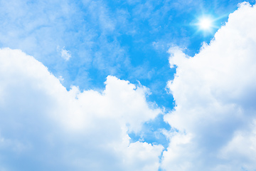 Image showing typical blue sky with sun and clouds background