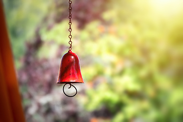 Image showing red color bell in the garden with bokeh background