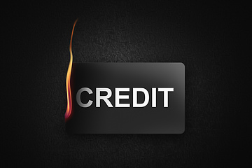 Image showing burning credit card on black background