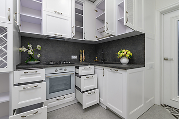 Image showing Open doors and drawers open at modern white kitchen