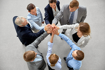 Image showing business people making high five in office