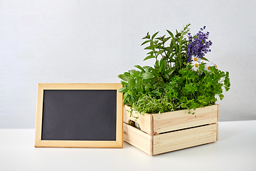Image showing herbs and flowers in wooden box with chalkboard