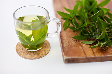 Image showing herbal tea with fresh peppermint on wooden board