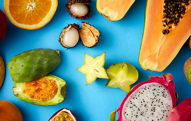 Image showing different exotic fruits on blue background