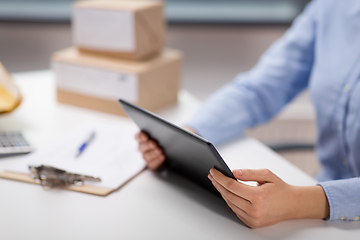 Image showing close up of woman with tablet pc at post office