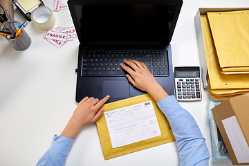 Image showing hands with laptop and envelope at post office