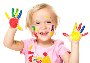 Image showing Portrait of a cute little girl playing with paints