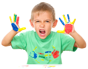 Image showing Portrait of a cute boy playing with paints