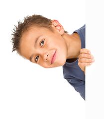 Image showing Little boy is looking out from the blank banner