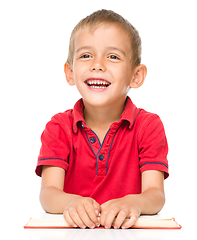 Image showing Little boy is reading a book