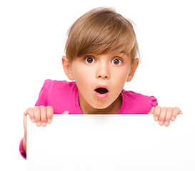 Image showing Little girl is looking out from the blank banner