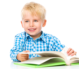 Image showing Little child play with book