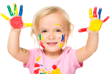 Image showing Portrait of a cute little girl playing with paints