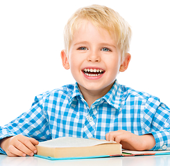 Image showing Little child play with book