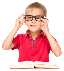 Image showing Little boy is reading a book