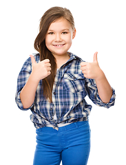 Image showing Little girl is showing thumb up gesture