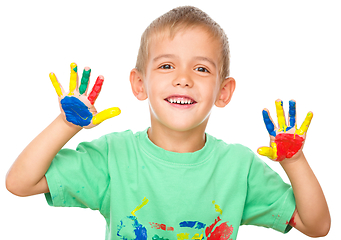 Image showing Portrait of a cute boy playing with paints