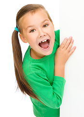 Image showing Little girl is looking from out blank board