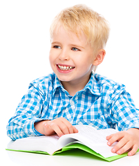 Image showing Little child play with book