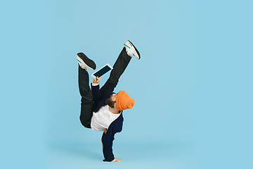 Image showing Businessman having fun dancing break dance on blue background at work