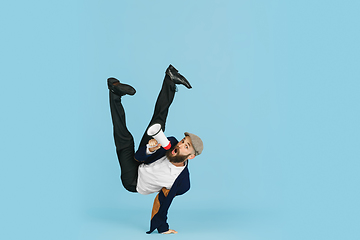 Image showing Businessman having fun dancing break dance on blue background at work