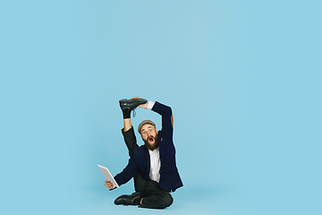 Image showing Businessman having fun dancing break dance on blue background at work