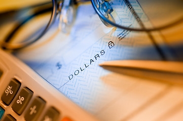 Image showing check , calculator and glasses