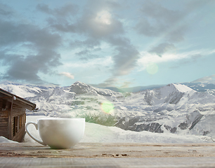 Image showing Single tea or coffee mug and landscape of mountains on background