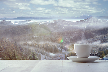 Image showing Single tea or coffee mug and landscape of mountains on background