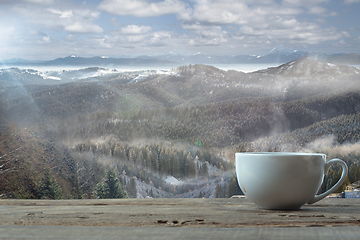 Image showing Single tea or coffee mug and landscape of mountains on background