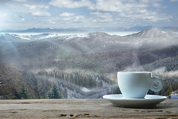 Image showing Single tea or coffee mug and landscape of mountains on background