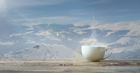 Image showing Single tea or coffee mug and landscape of mountains on background