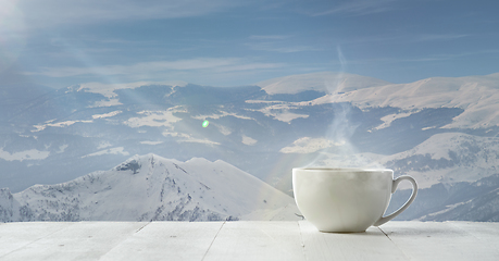 Image showing Single tea or coffee mug and landscape of mountains on background