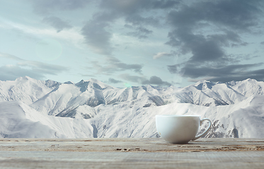 Image showing Single tea or coffee mug and landscape of mountains on background