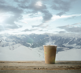 Image showing Single tea or coffee mug and landscape of mountains on background