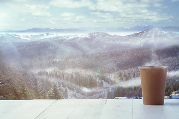 Image showing Single tea or coffee mug and landscape of mountains on background