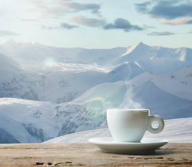 Image showing Single tea or coffee mug and landscape of mountains on background