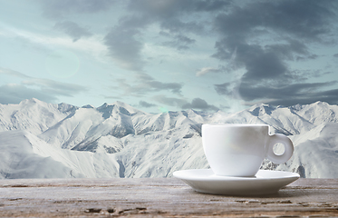 Image showing Single tea or coffee mug and landscape of mountains on background
