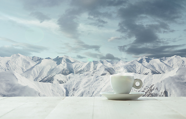 Image showing Single tea or coffee mug and landscape of mountains on background