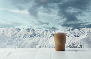 Image showing Single tea or coffee mug and landscape of mountains on background