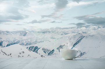 Image showing Single tea or coffee mug and landscape of mountains on background