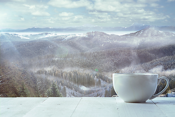 Image showing Single tea or coffee mug and landscape of mountains on background