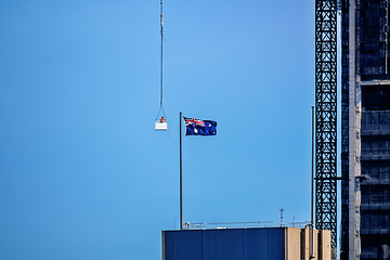 Image showing construction worker in a crane gondola near the Australia flag