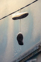 Image showing old shoes hanging on a wire