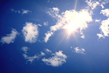 Image showing typical blue sky with sun and clouds background