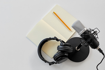 Image showing headphones, microphone and notebook with pencil